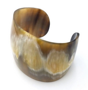 A brown horn cuff bracelet with a unique natural finish.